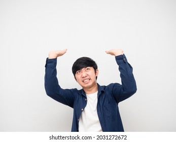 Asian man gesture carry something serious face,Asian man gesture carry product on his head white background