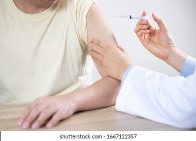 Asian Man Get Coronavirus, Flu And Measles Vaccine Shot, Vaccination In Hospital For Good Heath, Medicine Injection Vial Dose For Treatment Patient. (select Focus)