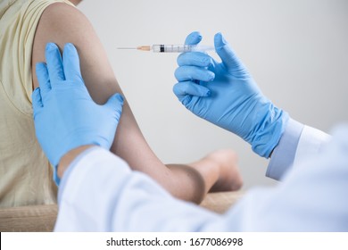 Asian Man Get Coronavirus, Flu And Measles Vaccine Shot, Vaccination In Hospital For Good Heath, Medicine Injection Vial Dose For Treatment Patient. (select Focus)