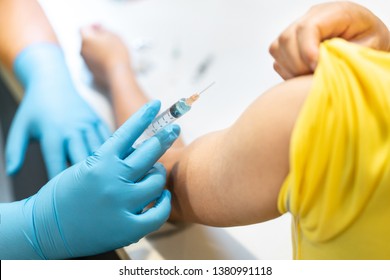 Asian man get hpv, flu and measles vaccine shot, vaccination in hospital for good heath, medicine injection vial dose for treatment patient