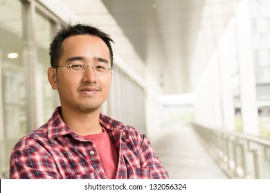 Asian Man With Glasses Stand At Street, Closeup Portrait.