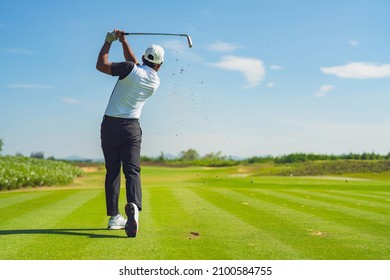 Asian man golfing on the course in summer - Shutterstock ID 2100584755