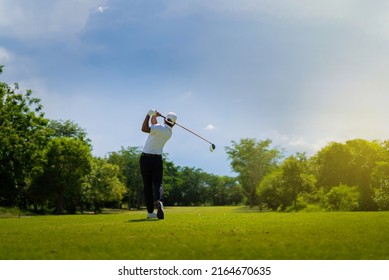 Asian man golfing on the course. In summer - Powered by Shutterstock