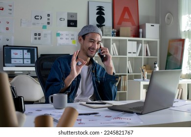 Asian man Graphic designer talking on mobile phone while working in office. Artist Creative Designer Illustrator Graphic Skill Concept. - Powered by Shutterstock