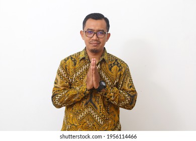 Asian man with greeting and welcoming gesture. Isolated on white background