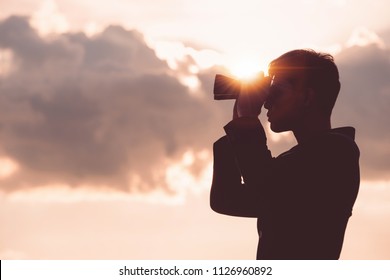 Asian man Hand Holding Binoculars / looking / watching using Binoculars with copyspace,Concept of The pursuit of profitable business in the future.