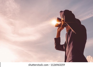 Asian Man Hand Holding Binoculars / Looking / Watching Using Binoculars With Copyspace,Concept Of The Pursuit Of Profitable Business In The Future.