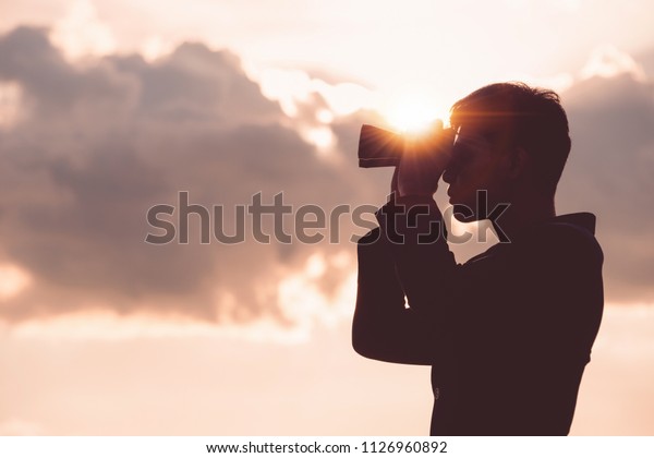 Asian man Hand Holding Binoculars / looking /\
watching using Binoculars with copyspace,Concept of The pursuit of\
profitable business in the\
future.