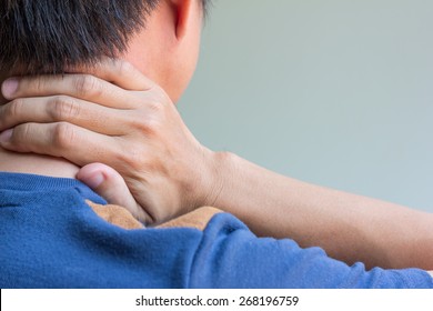 Asian man having neck pain and free space for text