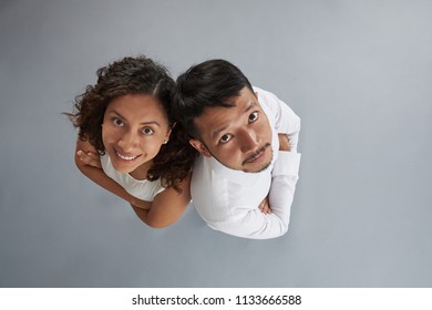 Asian Man And Hispanic Woman With Crossed Arms Isolated On Gray Background Above Top View