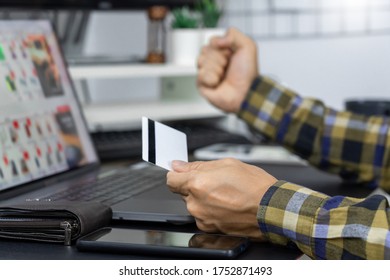 Asian man holding credit card to Online shopping with laptop computer and entering security code, internet banking or work from home consumer commerce concept - Shutterstock ID 1752871493