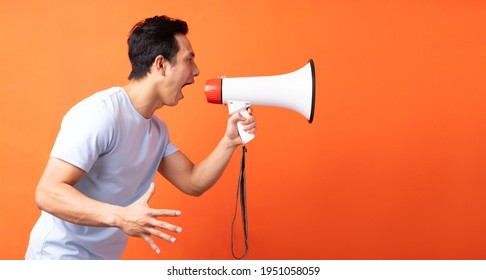 Asian Man Holding Megaphone And Shouting