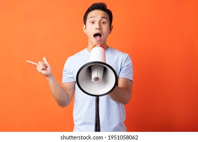 Asian Man Holding Megaphone And Shouting