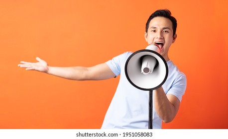 Asian Man Holding Megaphone And Shouting