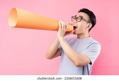 Asian Man Holding Paper Speaker On Pink Background	