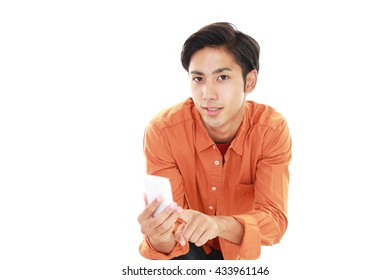  Asian man holding a smart phone - Shutterstock ID 433961146