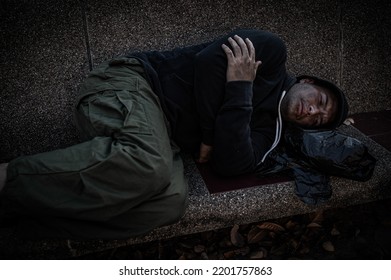 Asian man is homeless at the side road,A stranger has to live on the road alone because he has no family.