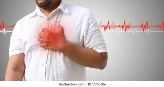 Asian man with hypertension heart - Shutterstock ID 1077768686
