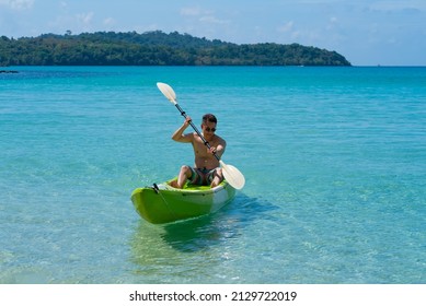 Asian Man kayaking in Blue Sea