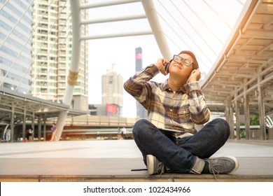 Asian Man  Listen To Music In Smartphone And Happy On Holiday With Easy Life. Time To Relax On City.