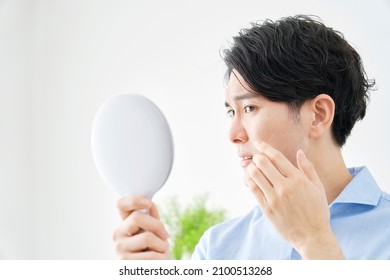 Asian Man Looking In The Mirror