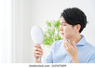 Asian Man Looking In The Mirror