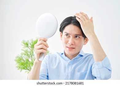 Asian Man Looking In The Mirror