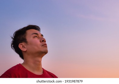 Asian man looking up to sky. Emotion face expression.