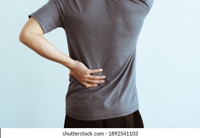 Asian Man With Lumbar Pain, Backache And Massage On Waist To Pain Relief.