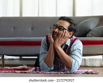 Asian Man Lying Down On The Floor Putting Hands On The Chin Gesture Like Thinking.