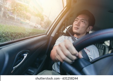 Asian Man Male Drive A Car And Looking At The Windows.