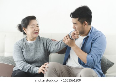 Asian man massage his mother at home, lifestyle concept. - Shutterstock ID 1551561209