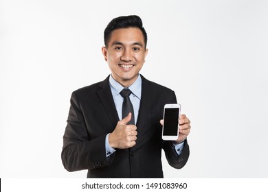 Asian man in office wear using his phone.