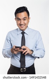 Asian man in office wear using his phone