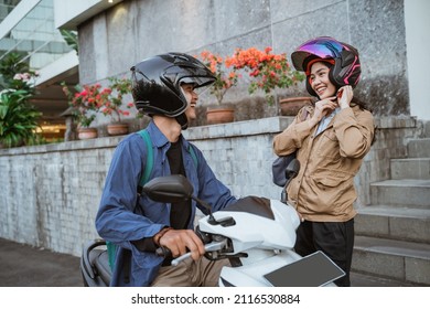 Asian Man On A Motorbike Picks Up A Woman