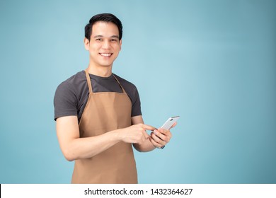 Asian Man Owner Standing with smart phone on blue backgrund. - Powered by Shutterstock