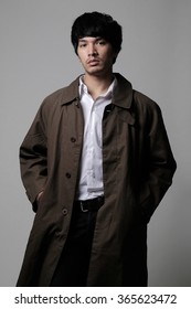 Asian Man Portrait In Vintage Look With Brown Coat