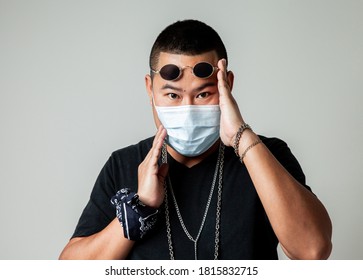 Asian Man In Rapper Style Wearing Hygienic Mask To Prevent The Virus . Hipster Man And All People In Masks To Outbreak Of Novel Corona Virus . Asian Hip Hop