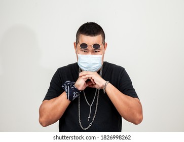 Asian Man In Rapper Style Wearing Hygienic Mask To Prevent The Virus . Hipster Man And All People In Masks To Outbreak Of Novel Corona Virus . Asian Hip Hop