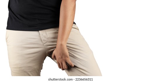 Asian man in reaction of scratching crotch on grey background, closeup. Annoying itch or Tinea Cruris. Human body problem or healthcare and medicine concept.