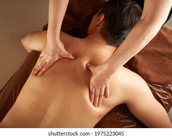 Asian man receiving back massage