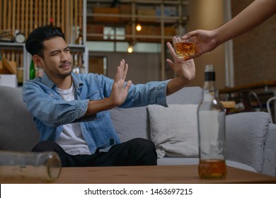 Asian Man Refusing Alcohol From Friend Or Another Person Because He Want To Quit Drinking Or Will Drive A Vehicle.