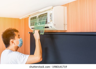 Asian Man Remove Dust Filter For Cleaning Air Conditioner System