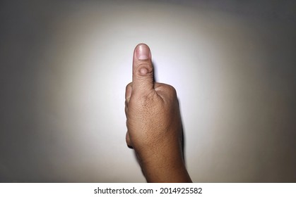 asian man right hand with calloused thumb pointing up