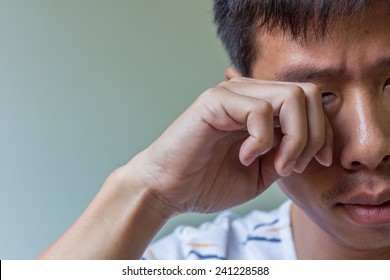 Asian Man Rubbing His Eyes