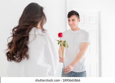 asian man send red rose to his girlfriend, asian female feeling surprise, they feeling happy and smile, happiness valentine's day