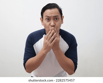 Asian man shocked and worried to see something bad, covering his mouth with hands and big eyes open, over grey background - Shutterstock ID 2282575457