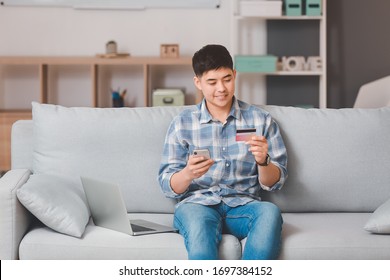 Asian Man Shopping Online At Home