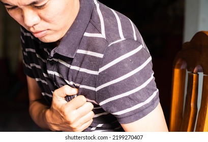 Asian Man Showing Chest Pain While Working Show Pain And Use Both Hands To Grip The Left Chest In Pain.