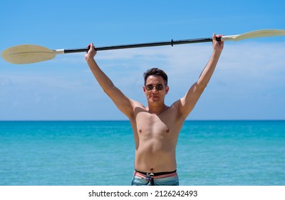 Asian Man Showing Paddle of Kayak Boat in Summer